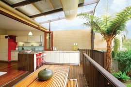 Slatted dining table and bench on a modern deck