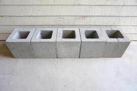 Stack five cinder blocks in a row