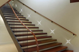 Staircase with star-like lights along the wall