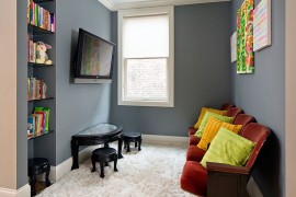 Tiny nook off of the hallway turned into kids' play zone and TV viewing space