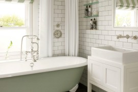 Traditional clawfoot tub in a bathroom with subway tile