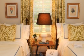 Twin beds in small guest room with matching curtains and pillows
