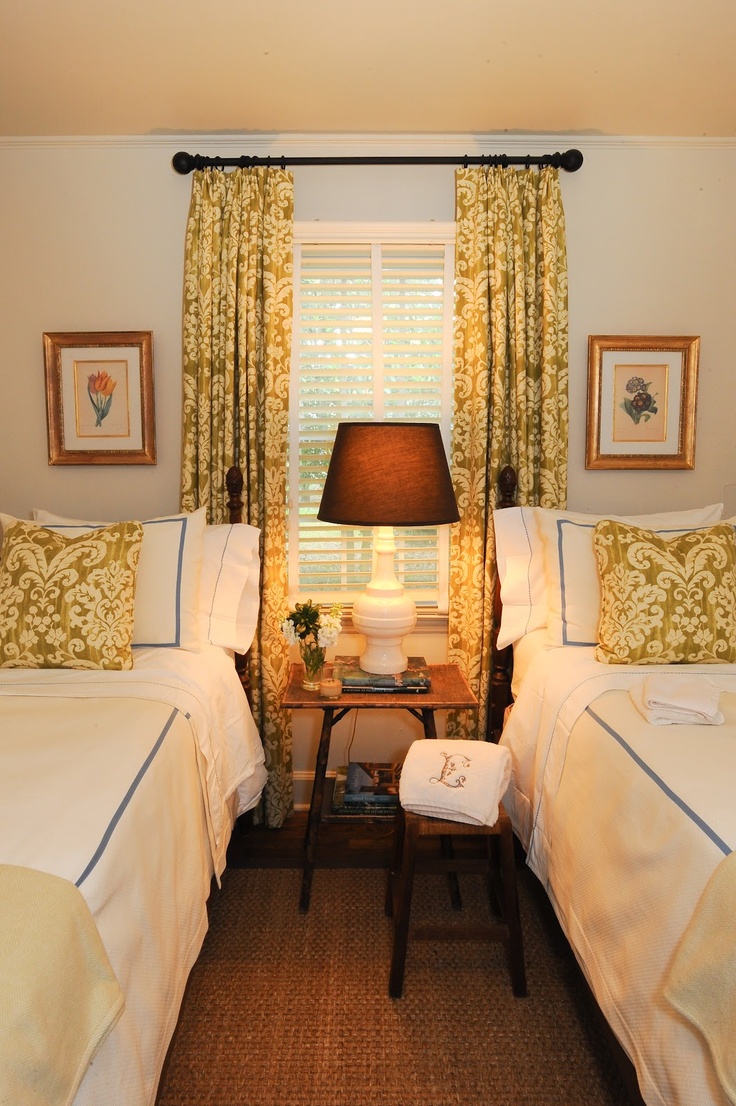 Twin beds in small guest room with matching curtains and pillows