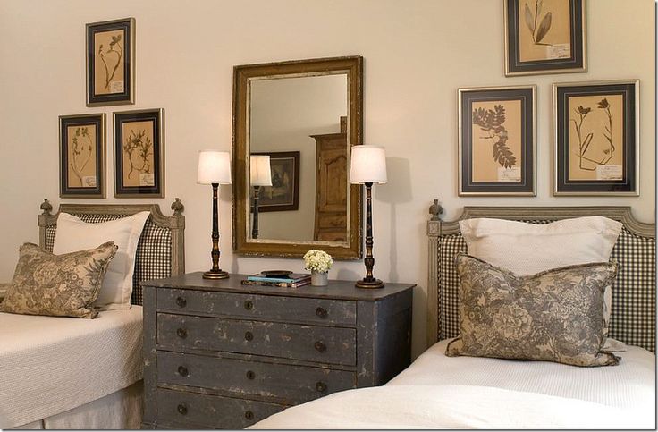 Twin beds with rustic dresser between them