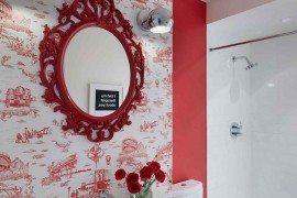 Wallpaper in red with interesting motif for the vivacious powder room