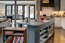 Walnut cabinet on casters offers a versatile addition to the kitchen island in gray [From: Bay Cabinetry & Design Studio]