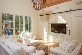 Barn doors slide open to reveal the television