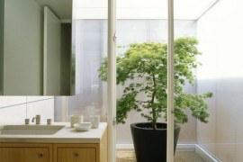 Bathroom with walkout to a bright courtyard