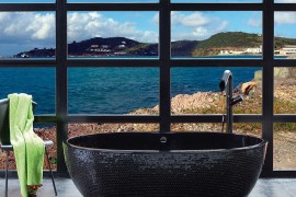 Beach style bathroom fetaures a sizzling stone black bathtub
