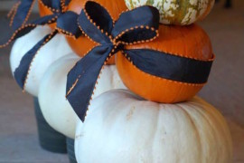 Beautiful pumpkins in planters with ribbon