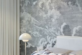 Bedroom with cloud wallpaper by Fornasetti at Cole & Son