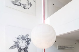 Black and white artwork creates a gallery style wall in the dining space