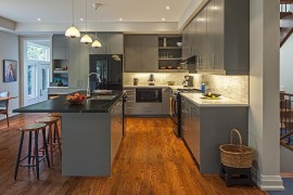 Black countertop and appliances offer lovely contrast in the all gray kitchen [From: Peter A. Sellar Photography / Vanbetlehem Architect]
