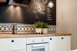 Chalkboard wall in the kitchen adds spunk to the interior