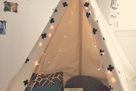 Classic and simple teepee stocked with pillows and books