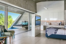 Contemporary bedroom with television wall and Ocean Views
