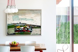 Contemporary dining room in white with lovely use of red accents