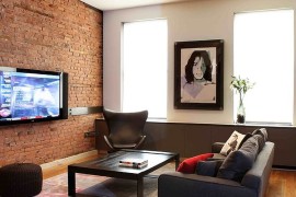 Contemporary living room with red brick wall and the classic Egg Chair [Design: valerie pasquiou interiors + design]