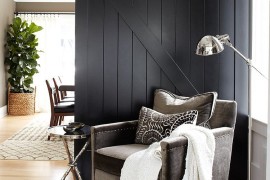 Dark black barn door fits in with the contemporary theme of the living room seamlessly