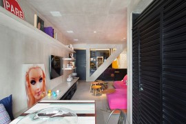 Eclectic decor and a sleek concrete bench in the living room