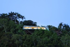 Fabulous futuristic home nestled among green canopy and overlooking Port Douglas in Queensland