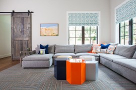 Gray of the barn door blends with the color palette of the living room