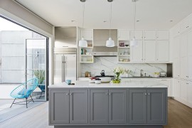 Kitchen with white and gray cabinets along with marble countertop and backsplash [Design: Art of Construction]