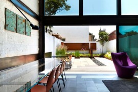 Large sliding glass doors connect the living area to the rear garden
