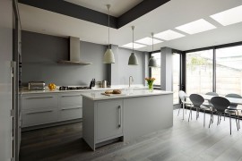 Lighting and flooring create a fusion between the various shades of gray in the kitchen