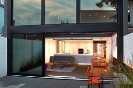 Massive glass windows and sliding doors open up the rear to the garden