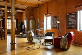 Open floor plan living area of industrial home in Edmonton [Design: AMR Interior Design & Drafting]