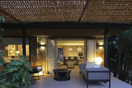 Outdoor sitting zone of the elegant Spanish home under the wicker pergola