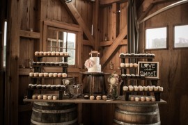 Rustic wedding table display using wine barrels