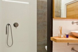 Shower area of the small bathroom in tile and concrete
