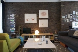 Simple and stylish decorating idea for living room with brick walls [Design: Katherine Hammond / Elizabeth Felicella Photography]