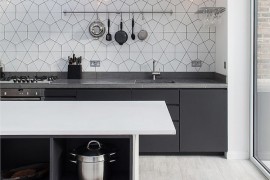 Simplicity of lighting and pattern of the backsplash hold your attention in this Scandinavian kitchen
