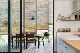 Sliding glass doors between the kitchen and the dining on the deck