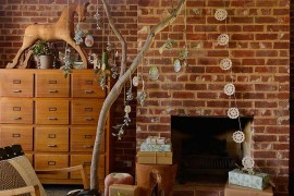 Small eclectic living room with brick wall and holiday decorations