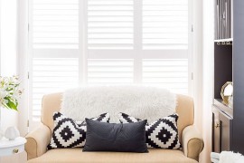 Small sofa in pastel hue turns out to be the focal point of the tiny living room