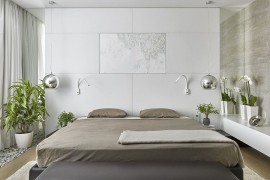 Soft white leather headboard wall, bedside pendants and greenery fashion a rejuvenating bedroom