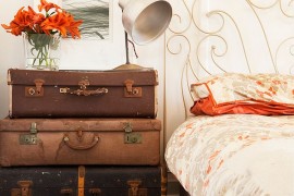 Stacked vintage suitcases serve both as bedside table and storage [Design: Twinkle and Whistle]