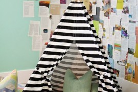 Striped teepee as a reading nook in a corner of the room