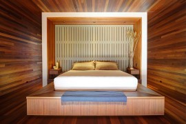 Stunning mahogany-lined master bedroom with platform bed