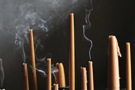 Tall black candlesticks with orange candles