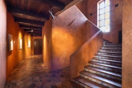 Textured walls, terra cotta tiles and lovely lighting create a warm, cozy home