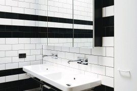 Tiny black and white bathroom with shower area