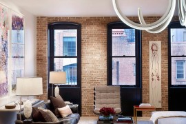 Tribeca residence with a brick wall living room [Design: Dirk Denison Architects]