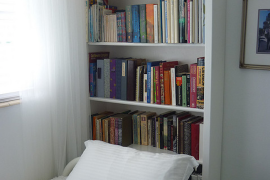 Use a bookshelf as a headboard for small rooms