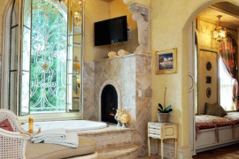 A tub with custom built-in fireplace fit for royalty