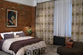 Accent brick wall in the bedroom with eclectic blend of prints [Design: 8.8 Design]